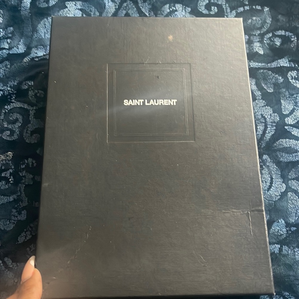Saint Laurent black full flap wallet on chain.